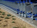 Baggage or luggage carts at an airport in a row Royalty Free Stock Photo