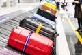 Baggage luggage on conveyor carousel belt at airport arrival Royalty Free Stock Photo