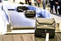 Baggage luggage on conveyor carousel belt at airport arrival Royalty Free Stock Photo