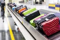 Baggage luggage on conveyor carousel belt at airport arrival Royalty Free Stock Photo