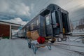 Baggage on a trolley outside a train in scandinavia, waiting to bi picked up and loaded onto a passenger train in the north. Snowy