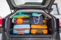 Baggages in the car trunk packed and ready to go for holidays Royalty Free Stock Photo