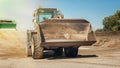 Bagger at construction aggregate dumps. Front view