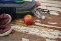 Bagpack, water bottle, apple, shoes and spectacle Royalty Free Stock Photo