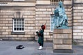 Bagpipe player next to the David Hume statue in Edinburgh