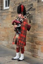 The street bagpiper in the city Edinburgh in Scotland.