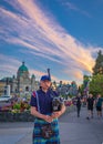 Bagpiper in Victoria BC. Scottish bagpiper dressed in traditional tartan dress playing bagpipers