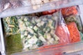 Bags with frozen vegetables in refrigerator. Frozen Zucchini Cubes