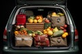 Bags full of groceries in car trunk outdoors. Open car trunk full of fresh food from grocery store