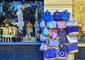 Bags with Greece printed on their sides hanging outside of souvenir shop