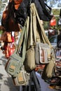 Bags hanging in market shop green khaki brown