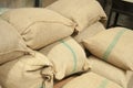 Bags in the warehouse on the racks. Coffee arabica, rice. Royalty Free Stock Photo