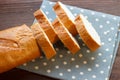 Baguette. Baguette slices on a linen napkin. Breakfast bread. Traditional French baguette cut into slices. Close-up. Royalty Free Stock Photo