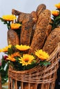 baguette of bread with flowers in a basket Royalty Free Stock Photo