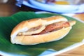 Baguette bread sandwich with cheese, ham on fresh Green banana leaf on wooden table in homemade Thai style Royalty Free Stock Photo