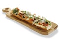 Baguette bruschetta ham with arugula cheese cherry tomato on wooden plate isolated background Royalty Free Stock Photo