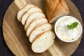 Baguette. French baguette slices and cream cheese on a wooden table. Fresh golden baguette on a wooden table. Serving bread and cr Royalty Free Stock Photo