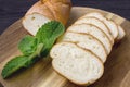 Baguette. French baguette slices on a wooden table. Fresh golden baguette on a wooden table. Breakfast bread. Serving bread. Royalty Free Stock Photo