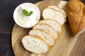 Baguette. French baguette slices and cream cheese on a wooden table. Fresh golden baguette on a wooden table. Serving bread and cr Royalty Free Stock Photo