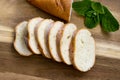 Baguette. French baguette slices on a wooden table. Breakfast bread. Royalty Free Stock Photo