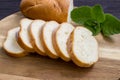 Baguette. French baguette slices on a wooden table. Fresh golden baguette on a wooden table. Breakfast bread. Serving bread. Close Royalty Free Stock Photo