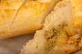 Baguette with garlic paste cut into pieces, close-up, selective focus Royalty Free Stock Photo