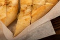 Baguette with garlic paste cut into pieces, close-up, selective focus Royalty Free Stock Photo