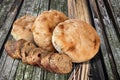 Three Freshly Baked Pitta Bread Loaves And Baguette Bread Slices Set On Old Weathered Cracked Picnic Table Grunge Surface Royalty Free Stock Photo