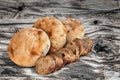 Freshly Baked Pitta Bread Loaves And Baguette Bread Slices Set On Old Knotted Weathered Cracked Picnic Table