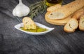 Baguette and olive oil dipping. Delicious Greek snack food and drink. Olive oil with herbs and garlic.