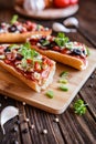 Baguette pizza with bacon, salami, cheese and vegetable