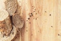 Baguette rye bread sprinkled with various seeds on a wooden board