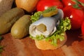 Baguette slice with sour herring, pickled herring