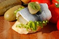 Baguette slice with sour herring, pickled herring