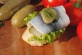 Baguette slice with sour herring, pickled herring