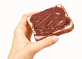 Baguette slice spread with nut-choco paste in man hand