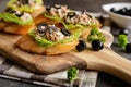 Baguette slices with tuna meat, onion, olives, egg and lettuce Royalty Free Stock Photo