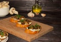 Baguette toast with soft cream cheese and mushrooms on a wooden Board. oil, garlic and mushrooms in the background. Snacks, quick Royalty Free Stock Photo