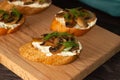 Baguette toast with soft cream cheese and mushrooms on a wooden Board. Snacks, quick breakfasts Royalty Free Stock Photo