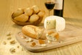 Baguettes in a basket, cheese and wine Royalty Free Stock Photo