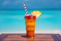 Bahama Mama Celebration Drink cocktail with straw on wooden table at the beach