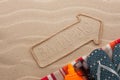 Bahamas pointer and beach accessories lying on the sand