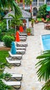 Bahamas, tropical scene, lounge chairs ready by pool, colorful Royalty Free Stock Photo