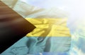 Bahamas waving flag against blue sky with sunrays