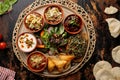 bahrain iftar and breakfast platter with samosa, raita, salad, bread, fruit chaat served in dish isolated on table top view of