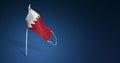 Bahrain mask on dark blue background. Waving flag of Bahrain painted on medical mask on pole. Concept of The banner of the fight