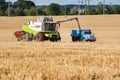 Baikivtsi, Ternopil Oblast, UKRAINE - August 10, 2020: A combine harvests wheat and loads it into a dump truck during the late