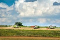 Baikivtsi, Ternopil Oblast, UKRAINE - August 10, 2020: harvesters CLAAS Lexion in the field through village gardens, the process