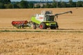 Baikivtsi, Ternopil Oblast, UKRAINE - August 10, 2020: sickle trailer hitched to CLAAS Lexion combine harvester for transportation