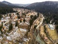 Aerial view of a small town surrounded by mountains.